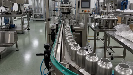 Stainless steel supplement packaging line with conveyor and tamper-evident sealing equipment in a clean production room
